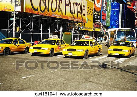 Yellow taxis on a road in a city, Times Square, Manhattan, New York City, New York State, USA View Large Photo Image Stock Image - Yellow taxis on a road in a city, Times Square, Manhattan, New York City, New York State, USA. Fotosearch