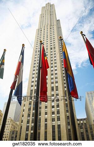 Low angle view of flags in front of a building, Rockefeller Center, Manhattan, New York City, New York State, USA View Large Photo Image Stock Photography - Low angle view of flags in front of a building, Rockefeller Center, Manhattan, New York City, New York State, USA. Fotosearch