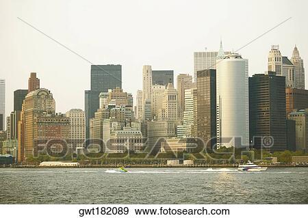 Skyscrapers at the waterfront in a city, New York City, New York State, USA View Large Photo Image Stock Photo - Skyscrapers at the waterfront in a city, New York City, New York State, USA. Fotosearch