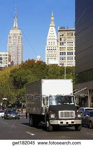 Traffic on a road with skyscrapers in the background, Empire State Building, Manhattan, New York City, New York State, USA View Large Photo Image Stock Photography - Traffic on a road with skyscrapers in the background, Empire State Building, Manhattan, New York City, New York State, USA. Fotosearch
