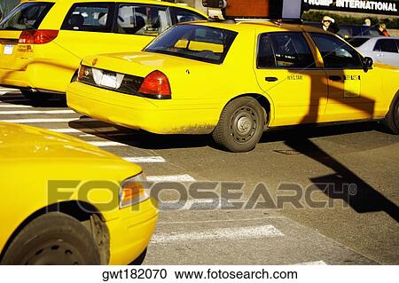 Yellow taxis on a road, Times Square, Manhattan, New York City, New York State, USA View Large Photo Image Stock Image - Yellow taxis on a road, Times Square, Manhattan, New York City, New York State, USA. Fotosearch