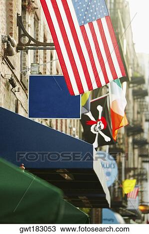 Stock Image - American flag hanging on the wall of a building, Savannah, Georgia, USA. Fotosearch