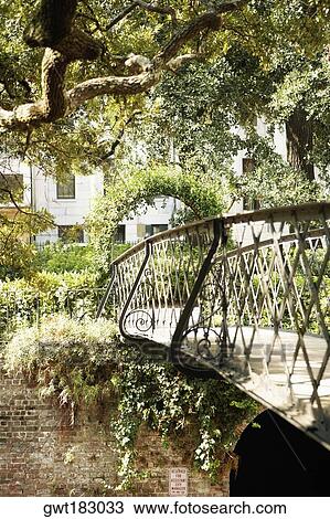 Stock Image - Trellis and the footbridge in a park, Savannah, Georgia, USA. Fotosearch