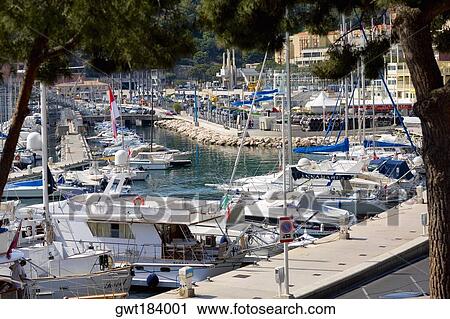 Boats docked at a harbor, Port of Fontvieille, Monte Carlo, Monaco View Large Photo Image Stock Image - Boats docked at a harbor, Port of Fontvieille, Monte Carlo, Monaco. Fotosearch