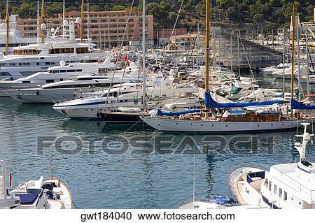 Boats docked at a harbor, Port of Fontvieille, Monte Carlo, Monaco View Large Photo Image Stock Image - Boats docked at a harbor, Port of Fontvieille, Monte Carlo, Monaco. Fotosearch