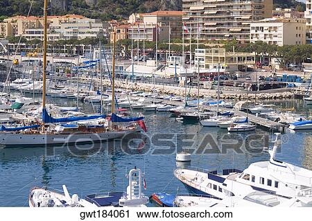 Boats docked at a harbor, Port of Fontvieille, Monte Carlo, Monaco View Large Photo Image Stock Image - Boats docked at a harbor, Port of Fontvieille, Monte Carlo, Monaco. Fotosearch