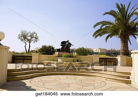 Palm tree and a statue in a garden, Monte Carlo, Monaco View Large Photo Image Stock Photography - Palm tree and a statue in a garden, Monte Carlo, Monaco. Fotosearch