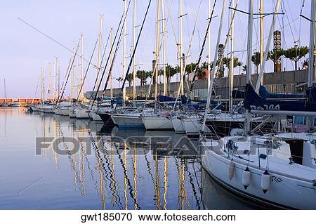 Stock Image - Boats moored at a port, Port Vell, Barcelona, Spain. Fotosearch