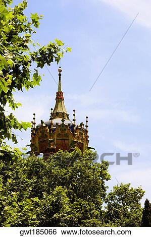 Stock Photograph - Trees in front of a tower, Barcelona, Spain. Fotosearch