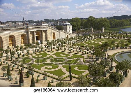 Picture - High angle view of a formal garden in front of a palace, Palace of Versailles, Versailles, France. Fotosearch