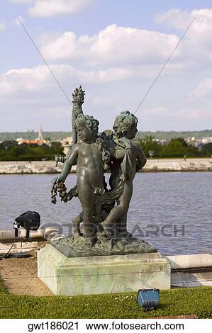 Statues near a pond in a formal garden, Palace of Versailles, Versailles, France View Large Photo Image Stock Image - Statues near a pond in a formal garden, Palace of Versailles, Versailles, France. Fotosearch