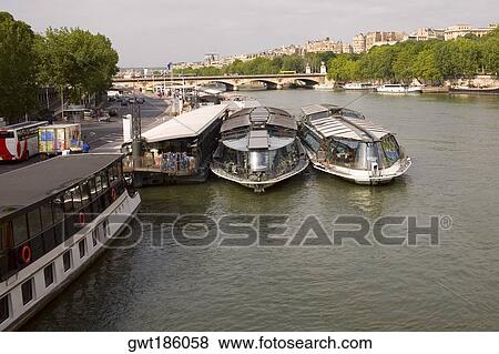 Tourboats docked at a port, Seine River, Paris, France View Large Photo Image Stock Photo - Tourboats docked at a port, Seine River, Paris, France. Fotosearch