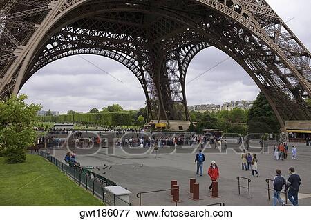 Tourists under a tower, Eiffel Tower, Paris, France View Large Photo Image Stock Photo - Tourists under a tower, Eiffel Tower, Paris, France. Fotosearch