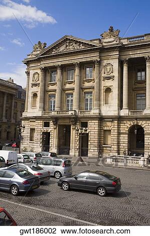 Stock Image - Traffic on a road in front of a building, Paris, France. Fotosearch