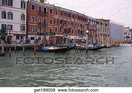 Boat docked in a canal in front of buildings, Grand Canal, Venice, Italy View Large Photo Image Stock Photo - Boat docked in a canal in front of buildings, Grand Canal, Venice, Italy. Fotosearch