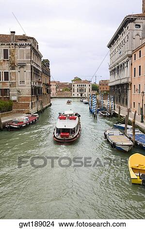 Picture - Boats and a water taxi in a canal, Venice, Italy. Fotosearch