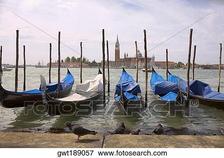 Stock Photo - Gondolas docked in a canal, Grand Canal, Venice, Italy. Fotosearch