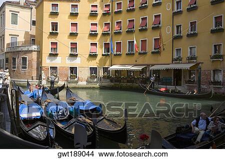 Gondolas docked in a canal near buildings, Venice, Italy View Large Photo Image Picture - Gondolas docked in a canal near buildings, Venice, Italy. Fotosearch
