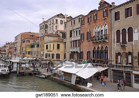 Group of people walking on a promenade along a canal, Venice, Italy View Large Photo Image Stock Image - Group of people walking on a promenade along a canal, Venice, Italy. Fotosearch