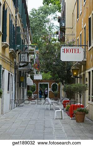 Rear view of two people in front of a hotel on the street, Venice, Italy View Large Photo Image Stock Image - Rear view of two people in front of a hotel on the street, Venice, Italy. Fotosearch