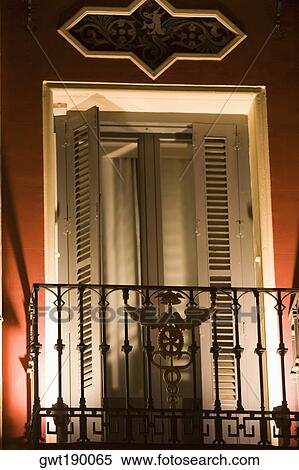 Balcony of a building lit up at night, Madrid, Spain View Large Photo Image Stock Photography - Balcony of a building lit up at night, Madrid, Spain. Fotosearch