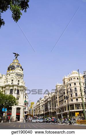 Buildings along a road in a city, Metropolis Building, Madrid, Spain View Large Photo Image Stock Image - Buildings along a road in a city, Metropolis Building, Madrid, Spain. Fotosearch