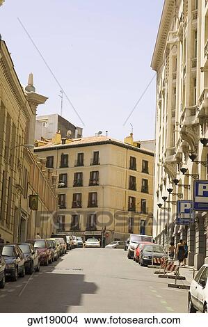 Picture - Cars parked on the street in front of buildings, Madrid, Spain. Fotosearch