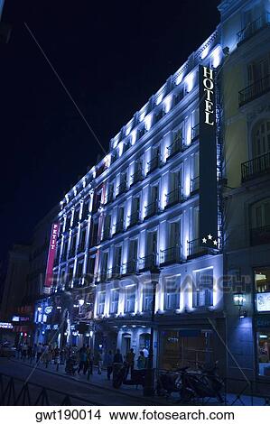 Picture - Low angle view of a hotel lit up at night, Madrid, Spain. Fotosearch