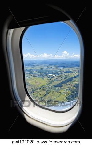 Aerial view of a landscape viewed through an airplane window View Large Photo Image Stock Photo - Aerial view of a landscape viewed through an airplane window. Fotosearch
