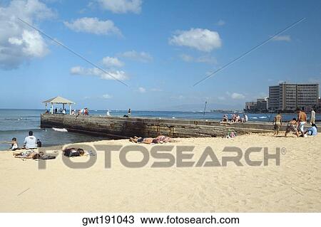 Stock Image - Group of people on the beach, Waikiki Beach, Honolulu, Oahu, Hawaii Islands, USA. Fotosearch