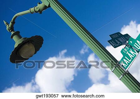 Low angle view of a signboard on a street light, Honolulu, Oahu, Hawaii Islands, USA View Large Photo Image Stock Photo - Low angle view of a signboard on a street light, Honolulu, Oahu, Hawaii Islands, USA. Fotosearch
