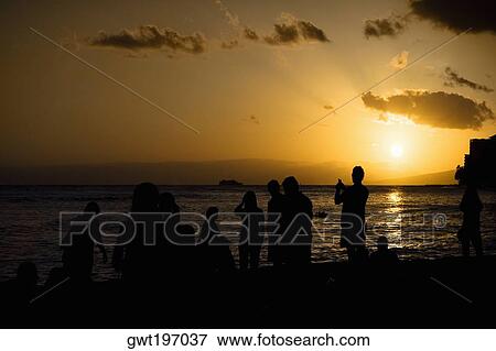 Group of people on the beach, Waikiki Beach, Honolulu, Oahu, Hawaii Islands, USA View Large Photo Image Stock Photo - Group of people on the beach, Waikiki Beach, Honolulu, Oahu, Hawaii Islands, USA. Fotosearch
