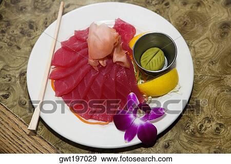 Stock Photo - High angle view of raw fish slices in a plate. Fotosearch