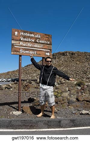 Mid adult man standing in front of an information board, Haleakala National Park, Maui, Hawaii Islands, USA View Large Photo Image Stock Photograph - Mid adult man standing in front of an information board, Haleakala National Park, Maui, Hawaii Islands, USA. Fotosearch