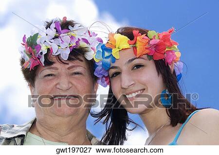 Portrait of a senior woman and her daughter wearing flowers View Large Photo Image Stock Photo - Portrait of a senior woman and her daughter wearing flowers. Fotosearch