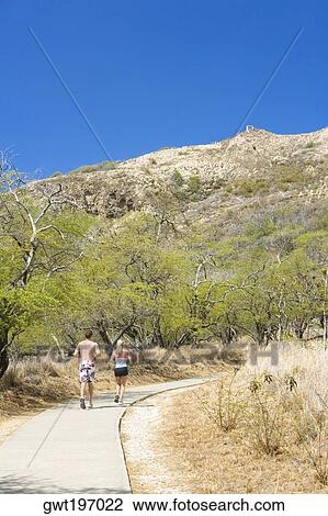 Rear view of a man and a woman running on a path, Diamond Head, Waikiki Beach, Honolulu, Oahu, Hawaii Islands, USA View Large Photo Image Stock Image - Rear view of a man and a woman running on a path, Diamond Head, Waikiki Beach, Honolulu, Oahu, Hawaii Islands, USA. Fotosearch