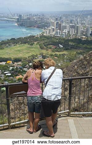Rear view of a man and a woman standing at an observation point, Diamond Head, Waikiki Beach, Honolulu, Oahu, Hawaii Islands, USA View Large Photo Image Picture - Rear view of a man and a woman standing at an observation point, Diamond Head, Waikiki Beach, Honolulu, Oahu, Hawaii Islands, USA. Fotosearch