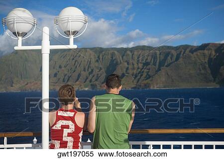 Rear view of tourists standing at observation point looking at a view, Na Pali Coast State Park, Kauai, Hawaii Islands, USA View Large Photo Image Stock Photography - Rear view of tourists standing at observation point looking at a view, Na Pali Coast State Park, Kauai, Hawaii Islands, USA. Fotosearch