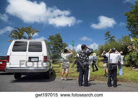 Rear view of tourists taking pictures in a forest, Akaka Falls State Park, Hilo, Big Island, Hawaii Islands, USA View Large Photo Image Stock Photography - Rear view of tourists taking pictures in a forest, Akaka Falls State Park, Hilo, Big Island, Hawaii Islands, USA. Fotosearch