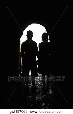 Stock Photo - Silhouette of a man and a woman standing in an archway, Diamond Head, Waikiki Beach, Honolulu, Oahu, Hawaii Islands, USA. Fotosearch