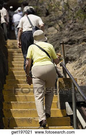 Stock Image - Tourists moving up on the staircase, Diamond Head, Waikiki Beach, Honolulu, Oahu, Hawaii Islands, USA. Fotosearch