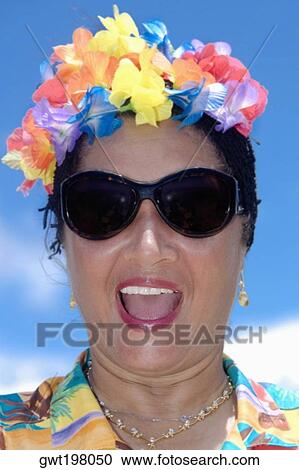 Close-up of a mid adult woman wearing flowers and shouting View Large Photo Image Stock Image - Close-up of a mid adult woman wearing flowers and shouting. Fotosearch