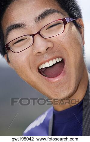 Close-up of a young man laughing View Large Photo Image Stock Image - Close-up of a young man laughing. Fotosearch