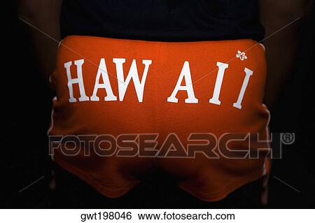 Mid section view of a person wearing shorts with Hawaii printed on it View Large Photo Image Stock Photograph - Mid section view of a person wearing shorts with Hawaii printed on it. Fotosearch