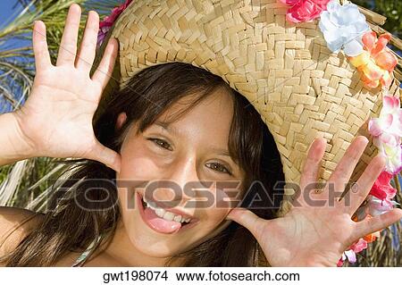 Portrait of a girl wearing a straw hat and sticking her tongue out View Large Photo Image Picture - Portrait of a girl wearing a straw hat and sticking her tongue out. Fotosearch