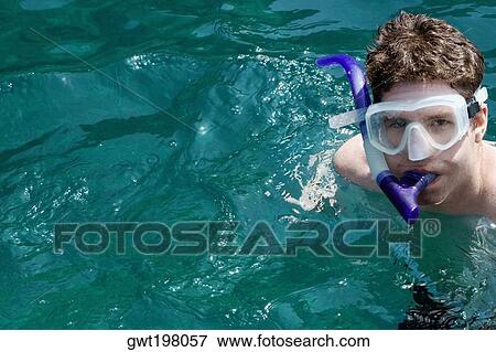 Portrait of a mid adult man snorkeling in the sea View Large Photo Image Stock Photo - Portrait of a mid adult man snorkeling in the sea. Fotosearch