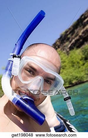 Portrait of a mid adult man wearing a snorkel View Large Photo Image Stock Photo - Portrait of a mid adult man wearing a snorkel. Fotosearch