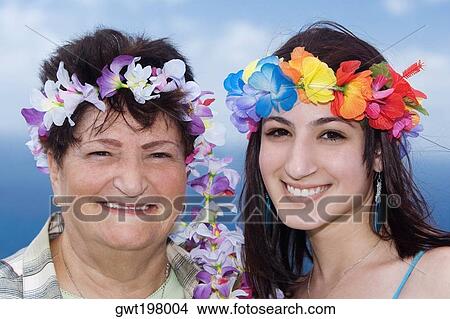 Portrait of a senior woman and her daughter wearing flowers View Large Photo Image Picture - Portrait of a senior woman and her daughter wearing flowers. Fotosearch