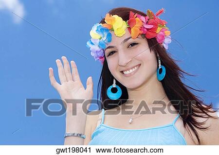 Portrait of a young woman wearing flowers and waving her hand View Large Photo Image Stock Image - Portrait of a young woman wearing flowers and waving her hand. Fotosearch