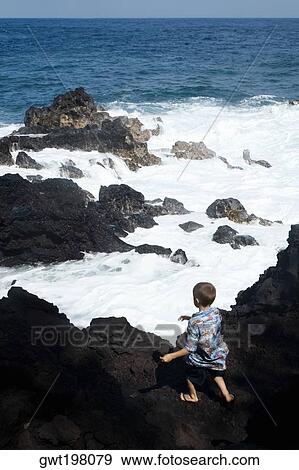 Rear view of a boy standing on a cliff, Kehena Beach, Big Island, Hawaii Islands, USA View Large Photo Image Stock Photo - Rear view of a boy standing on a cliff, Kehena Beach, Big Island, Hawaii Islands, USA. Fotosearch